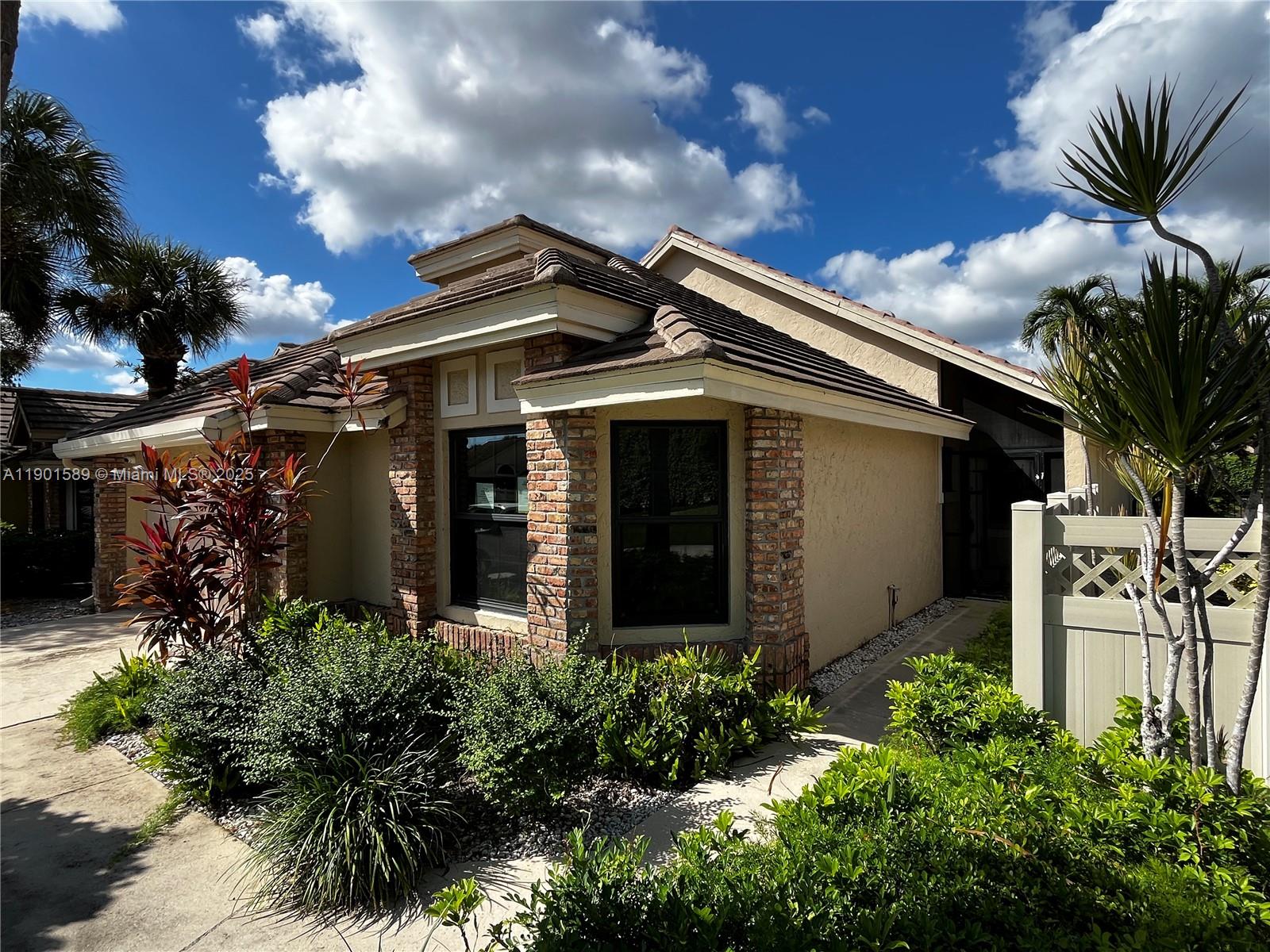 8079 Popash Court Boynton Beach, FL 33472 - Photo 26 of 30 a front view of a house with garden