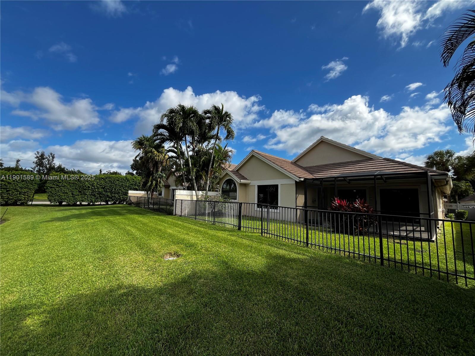 8079 Popash Court Boynton Beach, FL 33472 - Photo 5 of 30 a front view of a house with a garden
