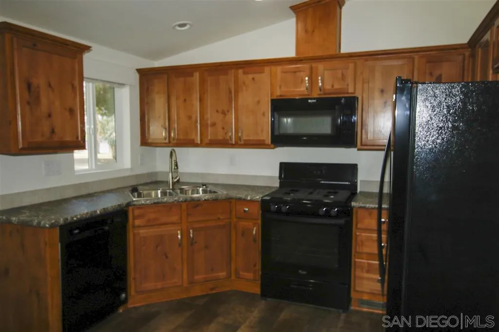 15726 Mussey Grade Road Ramona, CA 92065 - Photo 14 of 17 a kitchen with a sink and a stove top oven