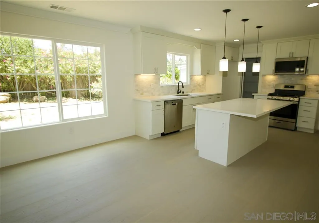 15726 Mussey Grade Road Ramona, CA 92065 - Photo 2 of 17 a kitchen with a sink stove and refrigerator