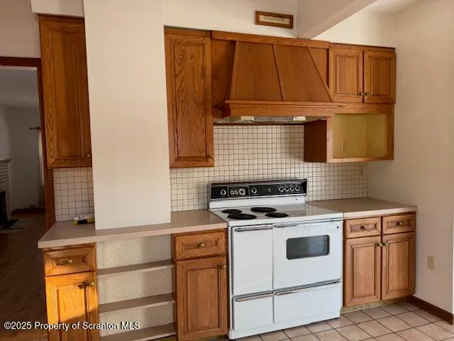 a kitchen with wooden cabinets and a stove top oven