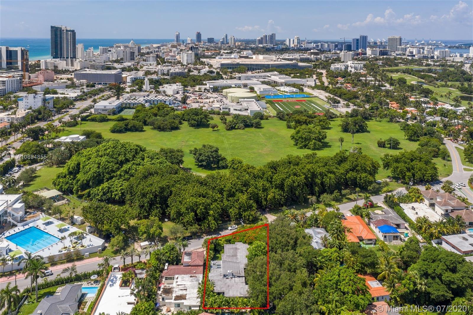 an aerial view of residential houses with city and lake view