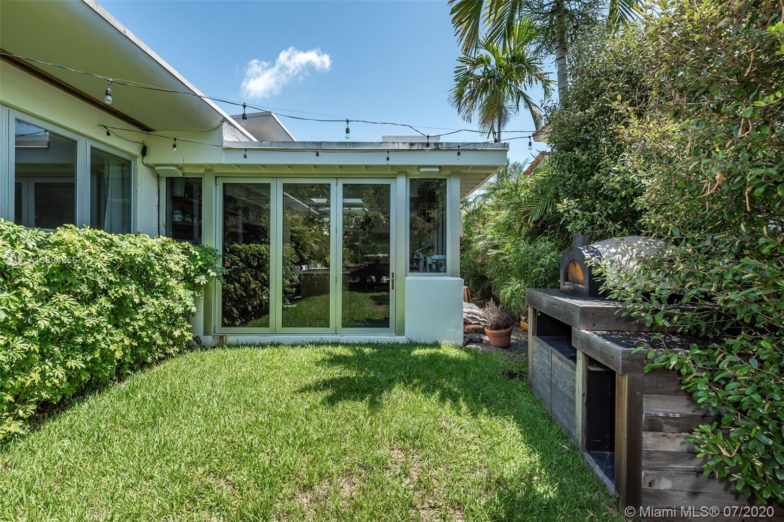 2801 Fairgreen Drive Miami Beach, FL 33140 - Photo 15 of 47 a view of a house with sitting area and garden