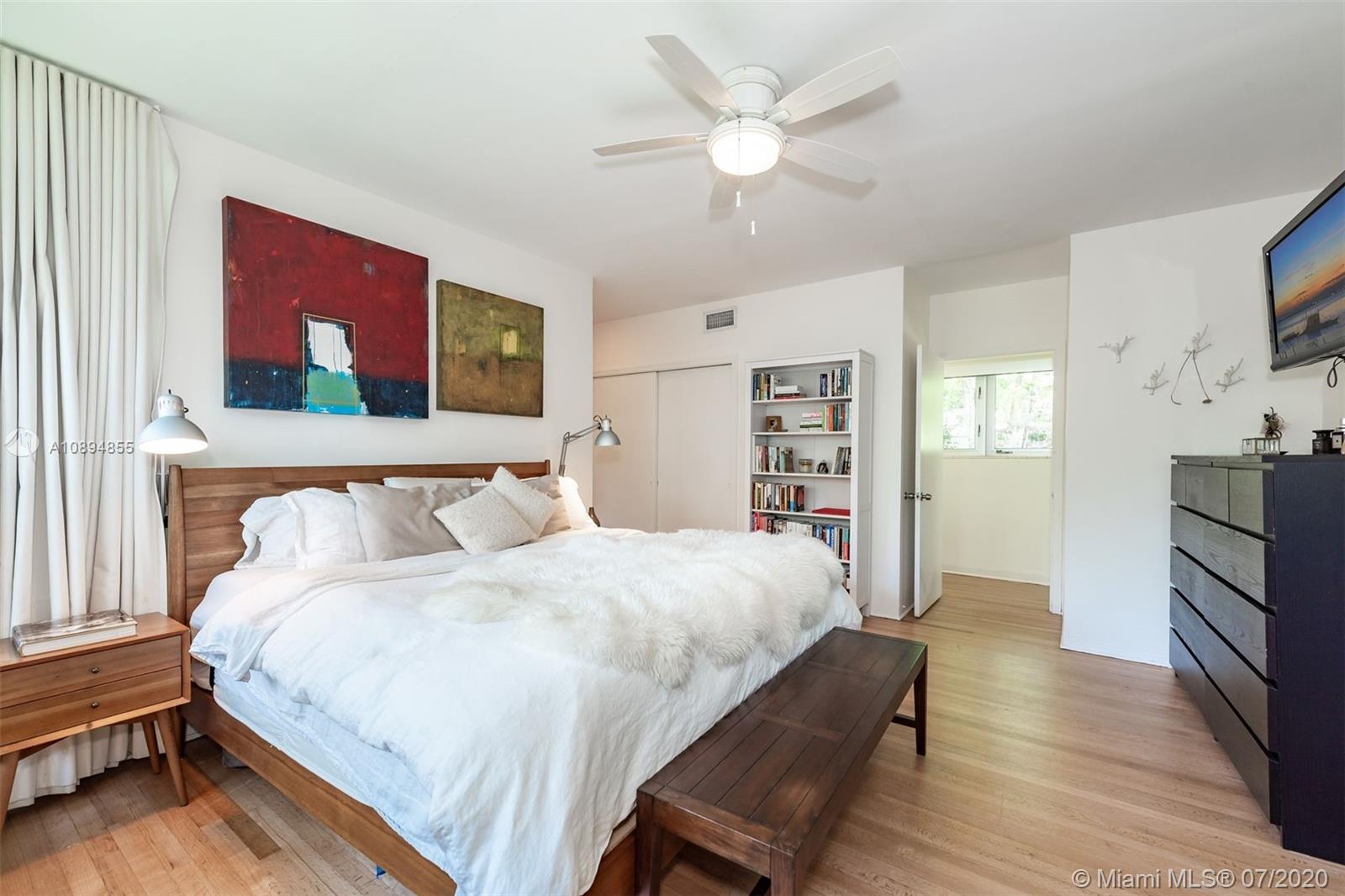 2801 Fairgreen Drive Miami Beach, FL 33140 - Photo 16 of 47 a spacious bedroom with a bed and a flat screen tv