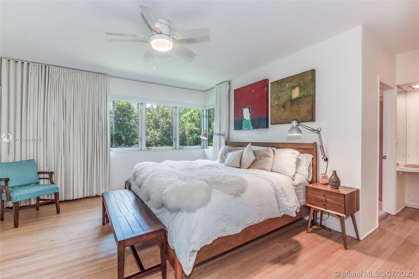 2801 Fairgreen Drive Miami Beach, FL 33140 - Photo 17 of 47 a bedroom with a bed and a chandelier