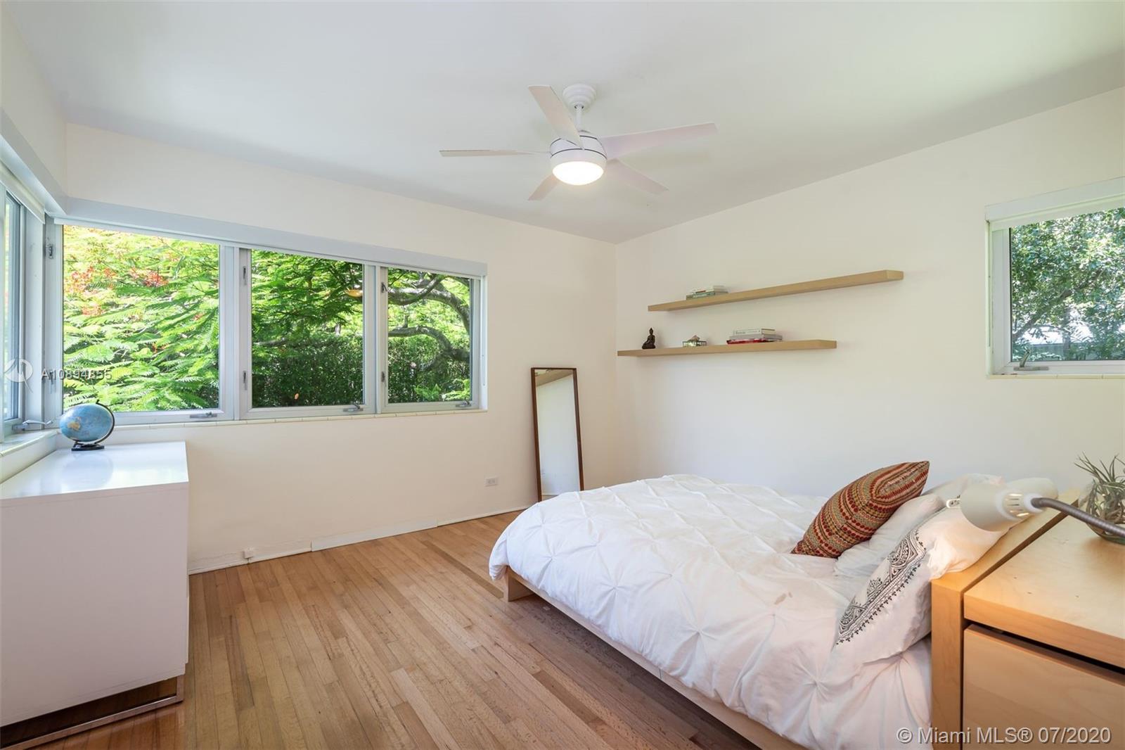 2801 Fairgreen Drive Miami Beach, FL 33140 - Photo 22 of 47 a bedroom with a bed and a large window