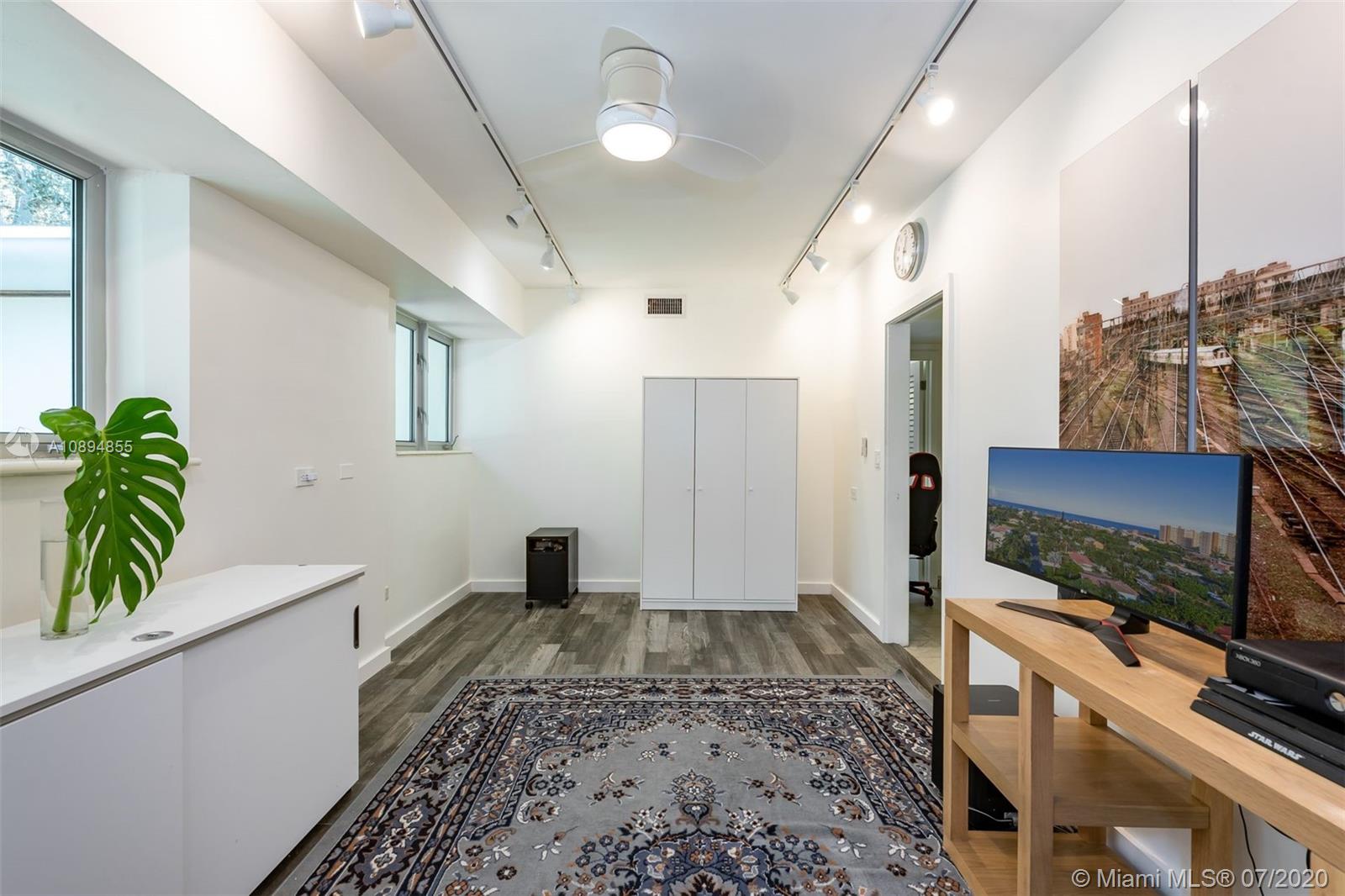 2801 Fairgreen Drive Miami Beach, FL 33140 - Photo 24 of 47 a living room with furniture and a flat screen tv