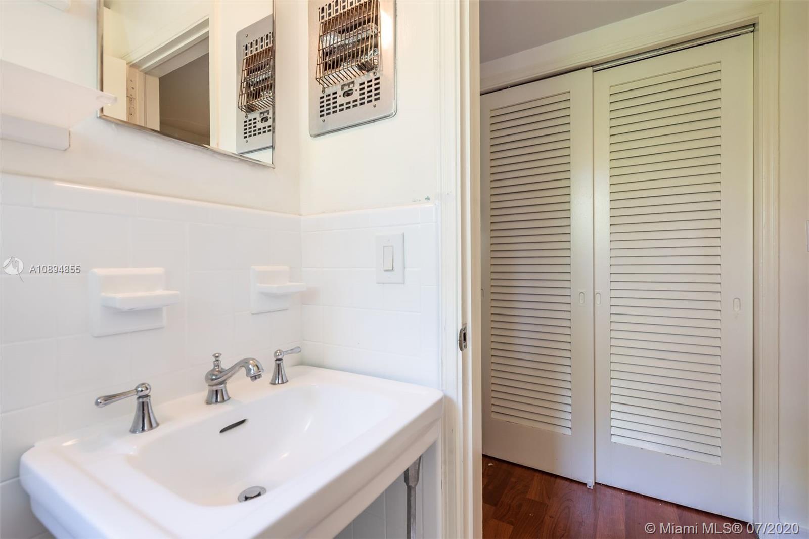 2801 Fairgreen Drive Miami Beach, FL 33140 - Photo 26 of 47 a bathroom with a sink and a mirror