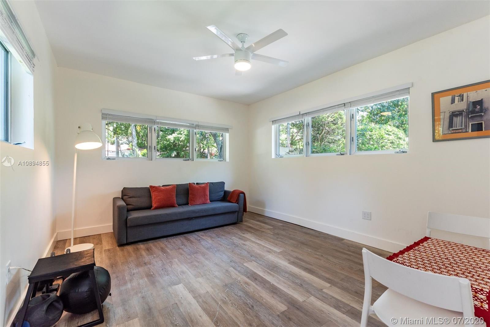 2801 Fairgreen Drive Miami Beach, FL 33140 - Photo 27 of 47 a living room with furniture and a large window