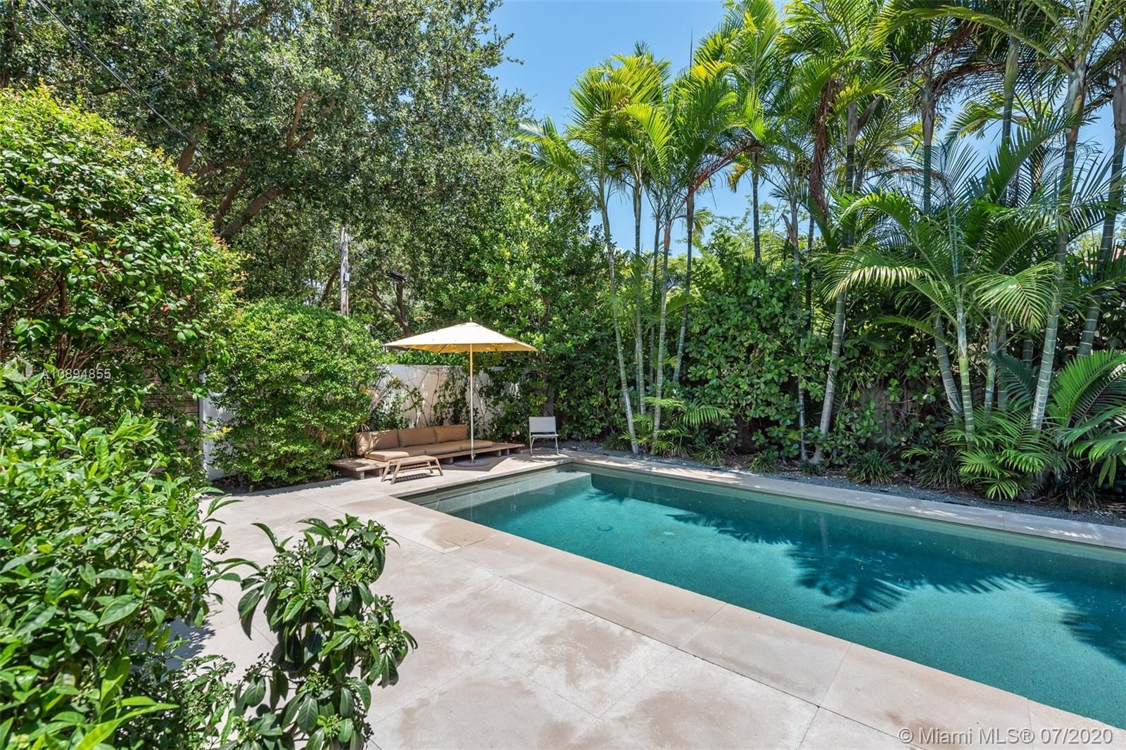 2801 Fairgreen Drive Miami Beach, FL 33140 - Photo 34 of 47 a view of a swimming pool with a yard table and chairs