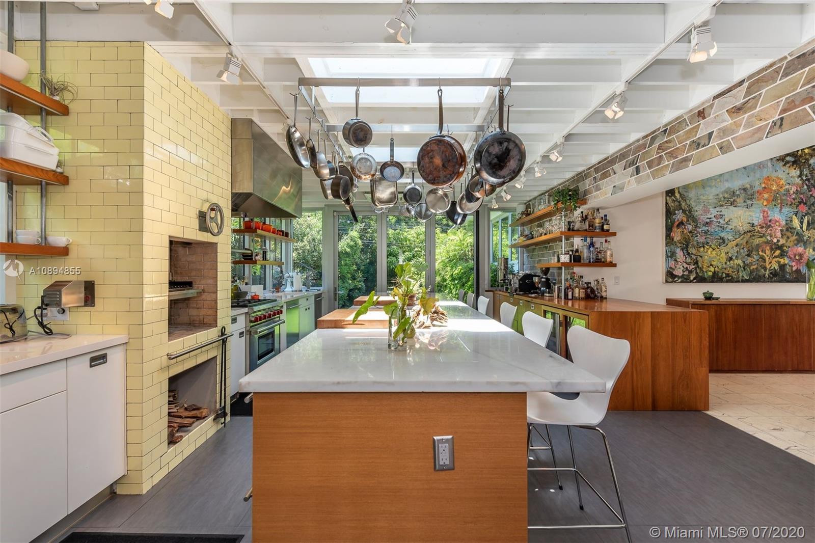 2801 Fairgreen Drive Miami Beach, FL 33140 - Photo 40 of 47 a kitchen with a table and chairs in it