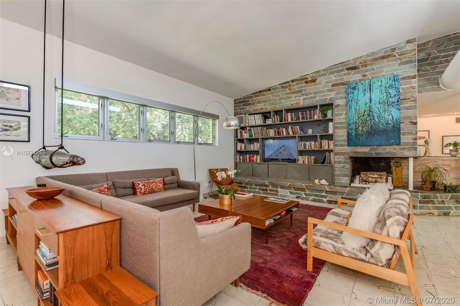 2801 Fairgreen Drive Miami Beach, FL 33140 - Photo 8 of 47 a living room with furniture and a book shelf