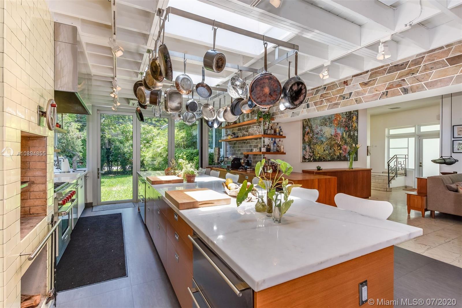 2801 Fairgreen Drive Miami Beach, FL 33140 - Photo 9 of 47 a view of a dining room with furniture and a chandelier