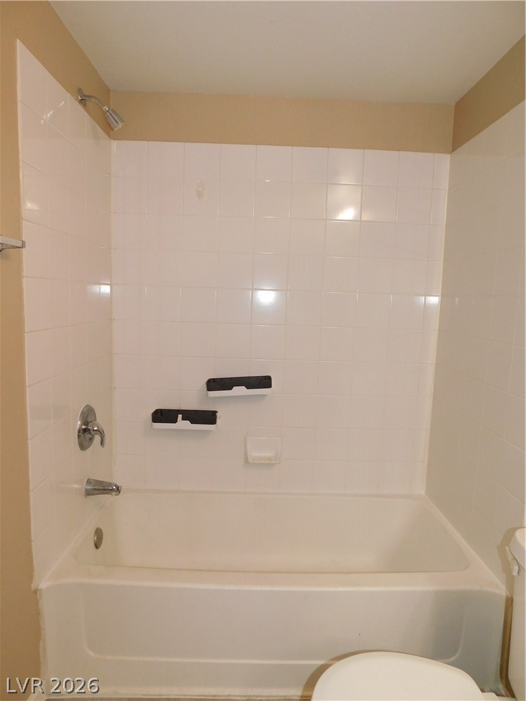 7255 West Sunset Road, Unit 2029 Las Vegas, NV 89113 - Photo 15 of 21 This functional shower area features classic tiled walls and floor, creating a clean, understated aesthetic.