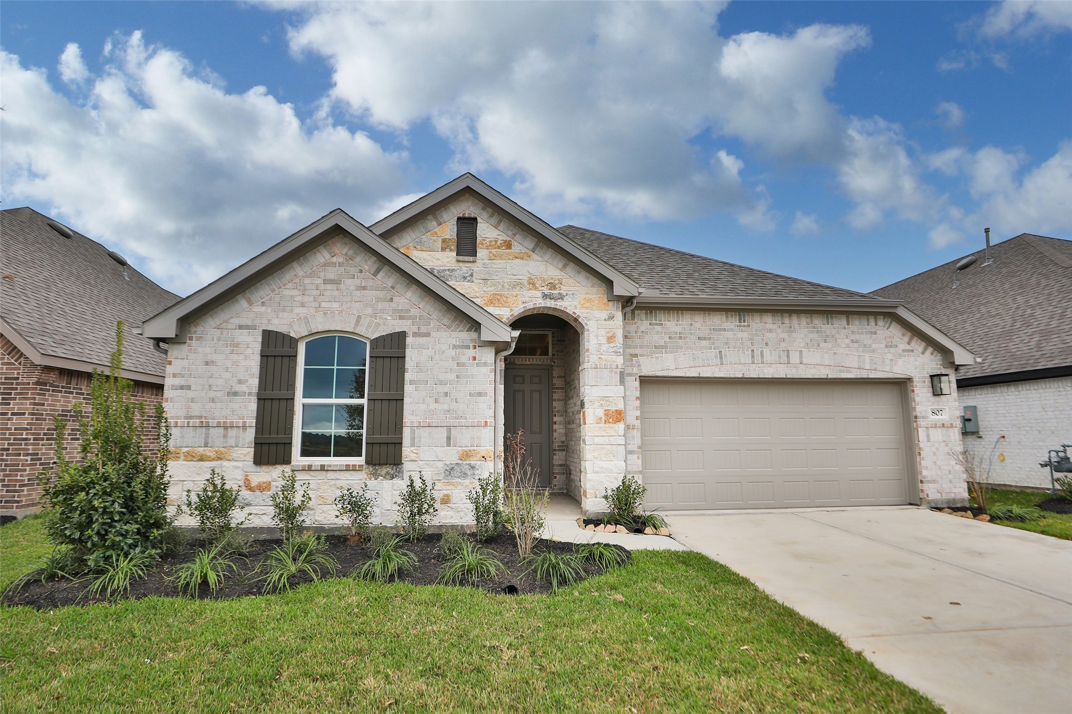 a front view of a house with a yard and garage