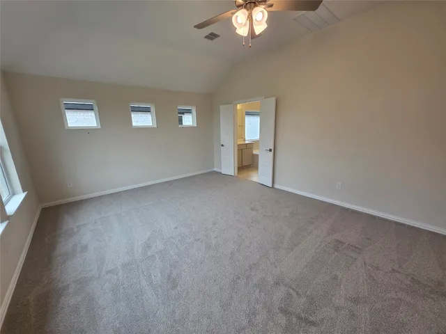 a view of a livingroom with a ceiling fan and window