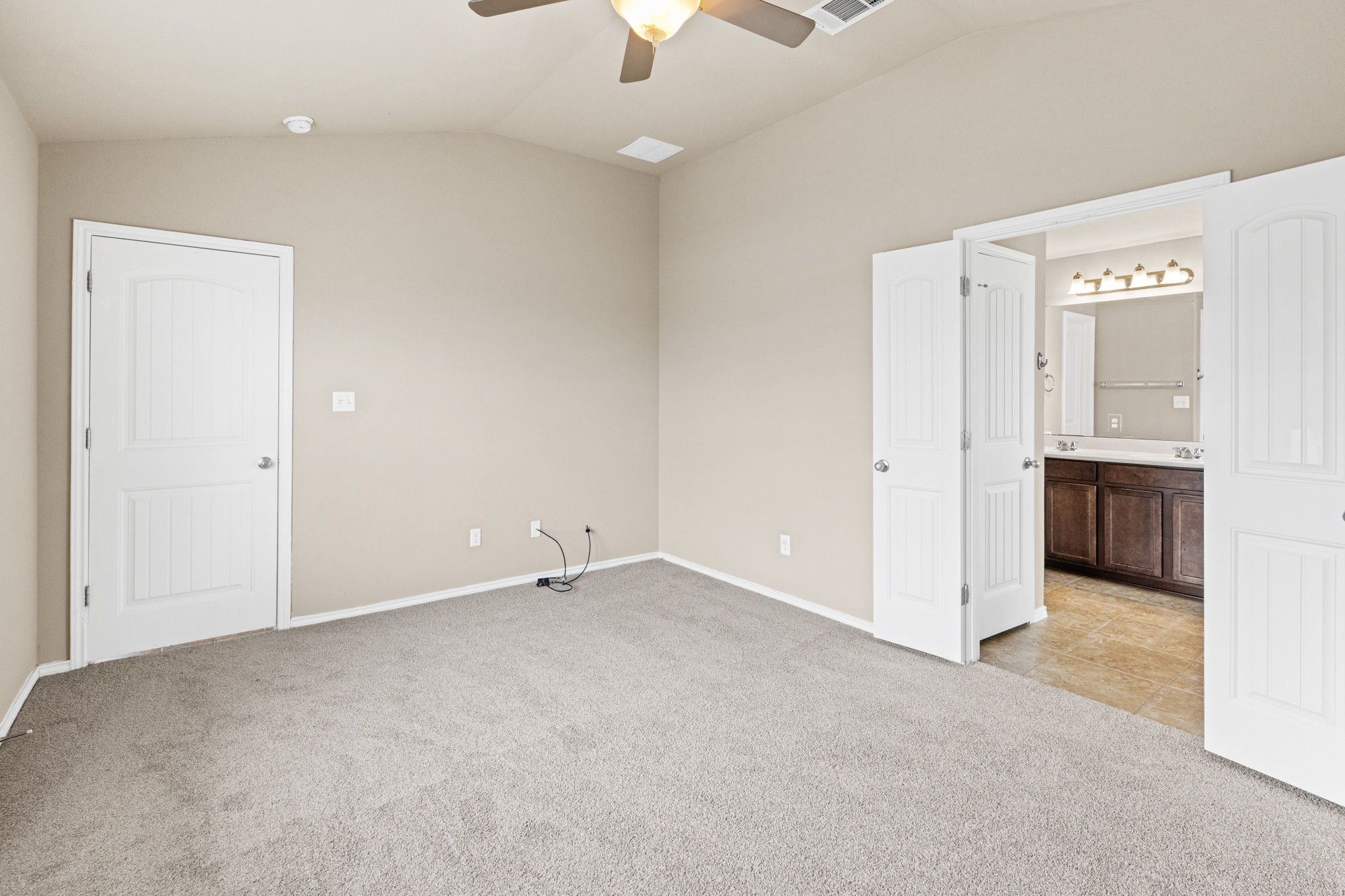 19308 Stokes Lane Pflugerville, TX 78660 - Photo 11 of 27 Carpeted interior space featuring a vaulted ceiling and a ceiling fan
