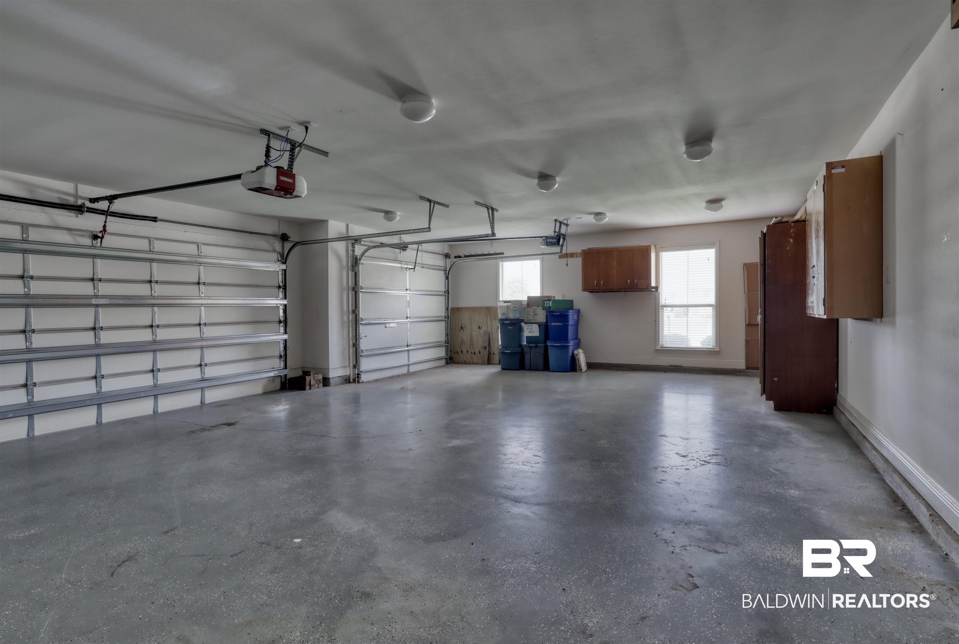 14794 Troon Drive Foley, AL 36535 - Photo 26 of 33 Garage featuring baseboards and a garage door opener