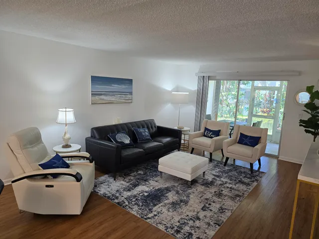 a living room with furniture rug and a large window