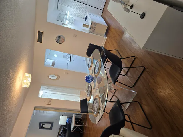 a view of entryway and hall with wooden floor