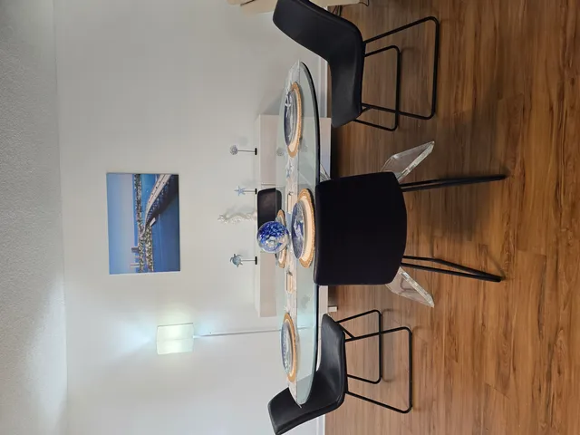 a dining room with furniture and wooden floor