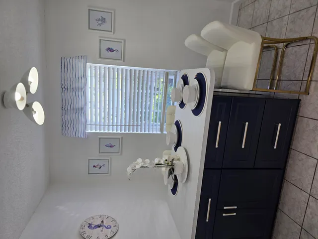 a picture of a bathroom with a mirror and vanity