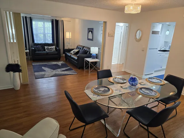 a view of a dining room with furniture and wooden floor
