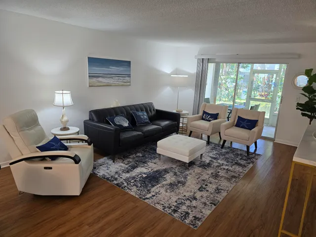 a living room with furniture rug and window