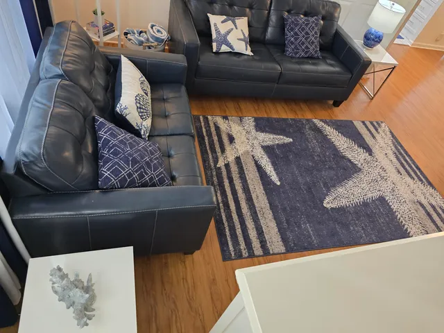 a living room with furniture and a rug