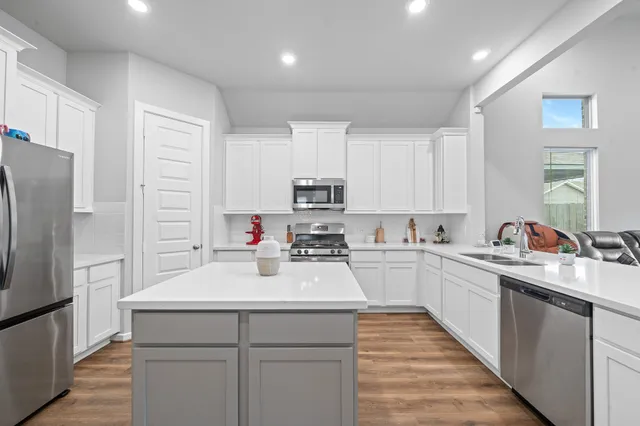 a kitchen with a sink appliances and cabinets