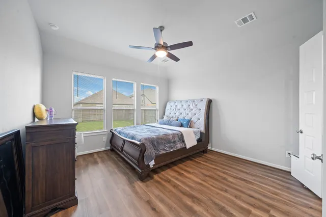 a bedroom with a large bed and a chandelier