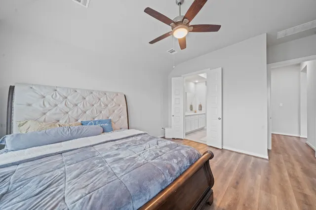 a spacious bathroom with a sink and mirror