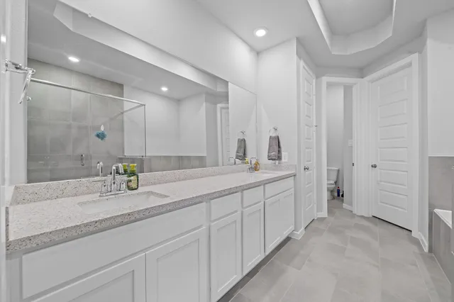 a bathroom with a tub a sink and a shower