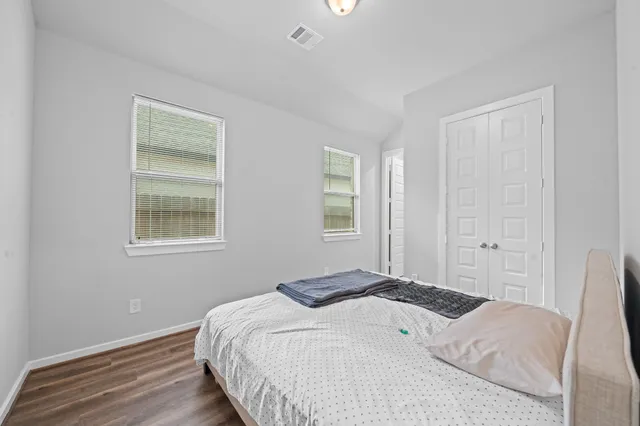 a bedroom with a bed and a view of kitchen