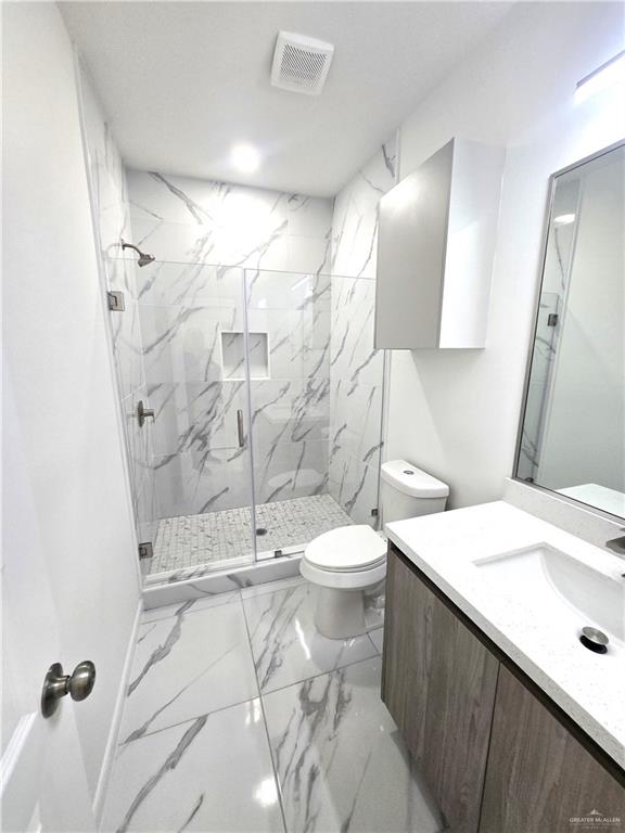 3201 Magdalena Street, Unit 9 Mission, TX 78573 - Photo 5 of 12 a bathroom with a sink a toilet and shower