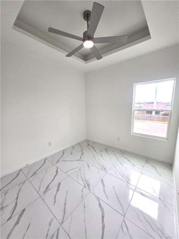 3201 Magdalena Street, Unit 9 Mission, TX 78573 - Photo 6 of 12 an empty room with windows and fan