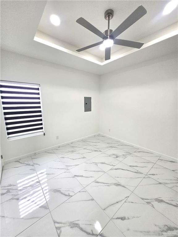 3201 Magdalena Street, Unit 9 Mission, TX 78573 - Photo 8 of 12 en empty room with windows and ceiling fan