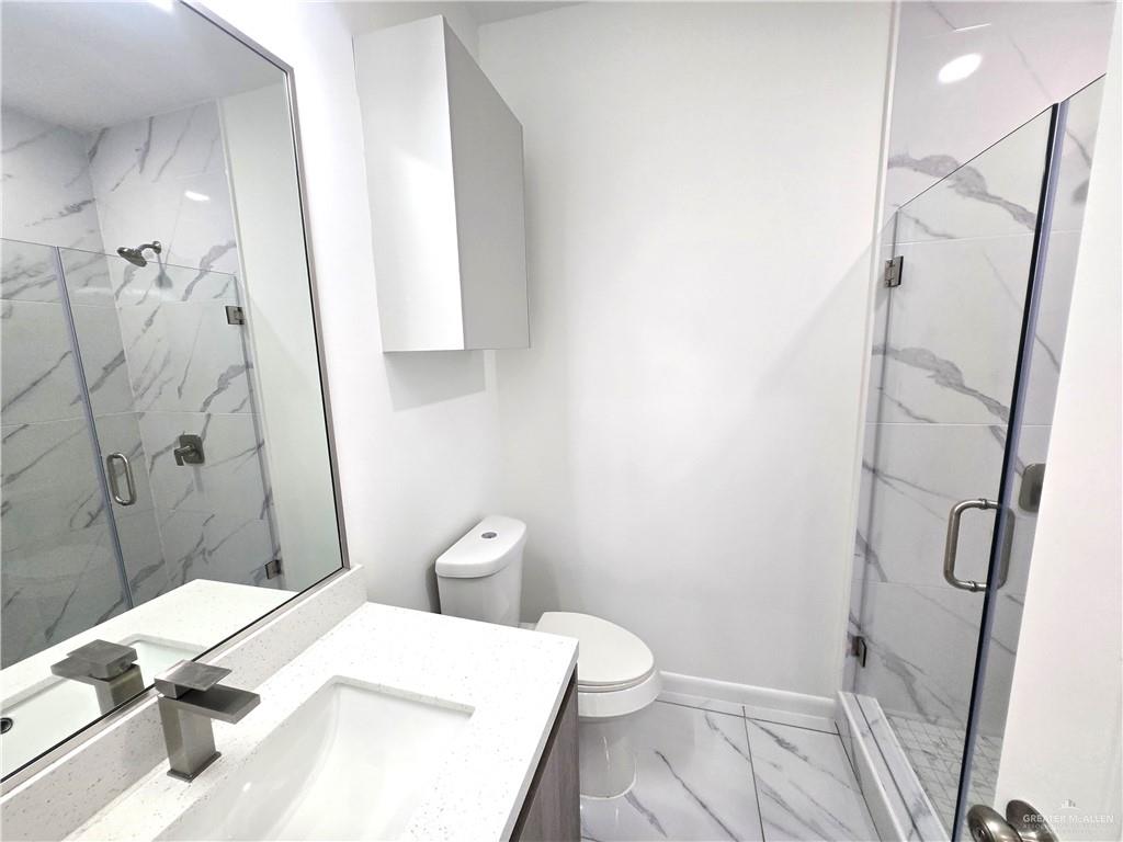 3201 Magdalena Street, Unit 9 Mission, TX 78573 - Photo 10 of 12 a bathroom with a sink and toilet