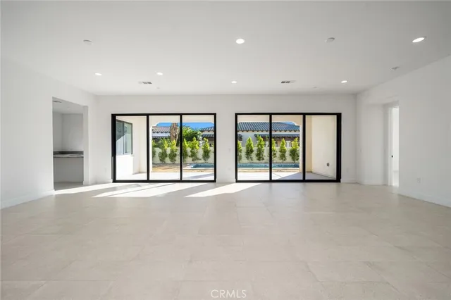 a kitchen with granite countertop a sink and white cabinets