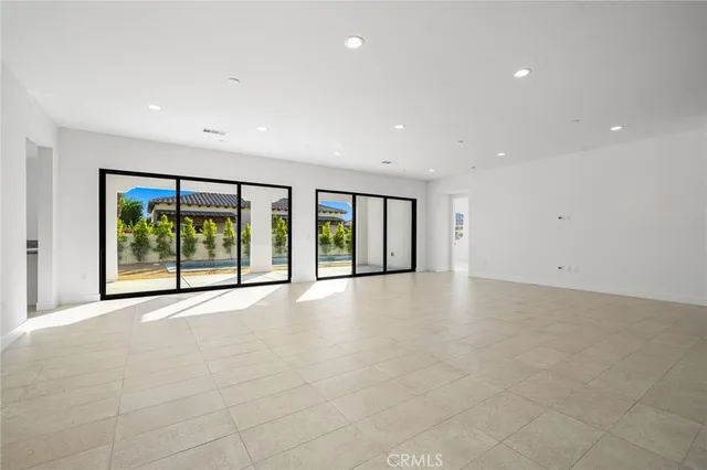 a view of a kitchen with refrigerator and a sink