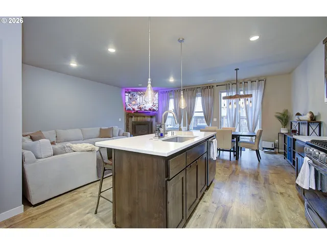 a kitchen with a stove a refrigerator and a dining table
