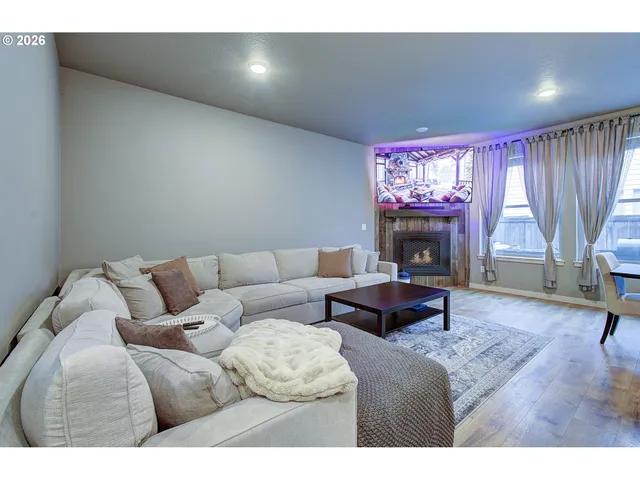 a living room with furniture and a fireplace