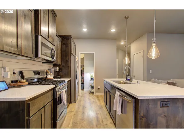 a kitchen with a sink stove and cabinets