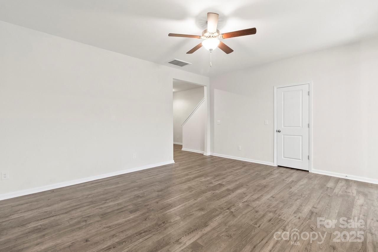 3776 Yorkshire Place Terrell, NC 28682 - Photo 20 of 47 an empty room with wooden floor ceiling fan and window