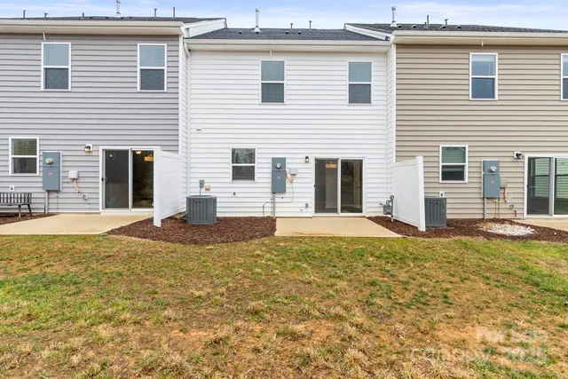 a view of a house with swimming pool and sitting area