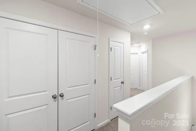 an empty room with chandelier fan