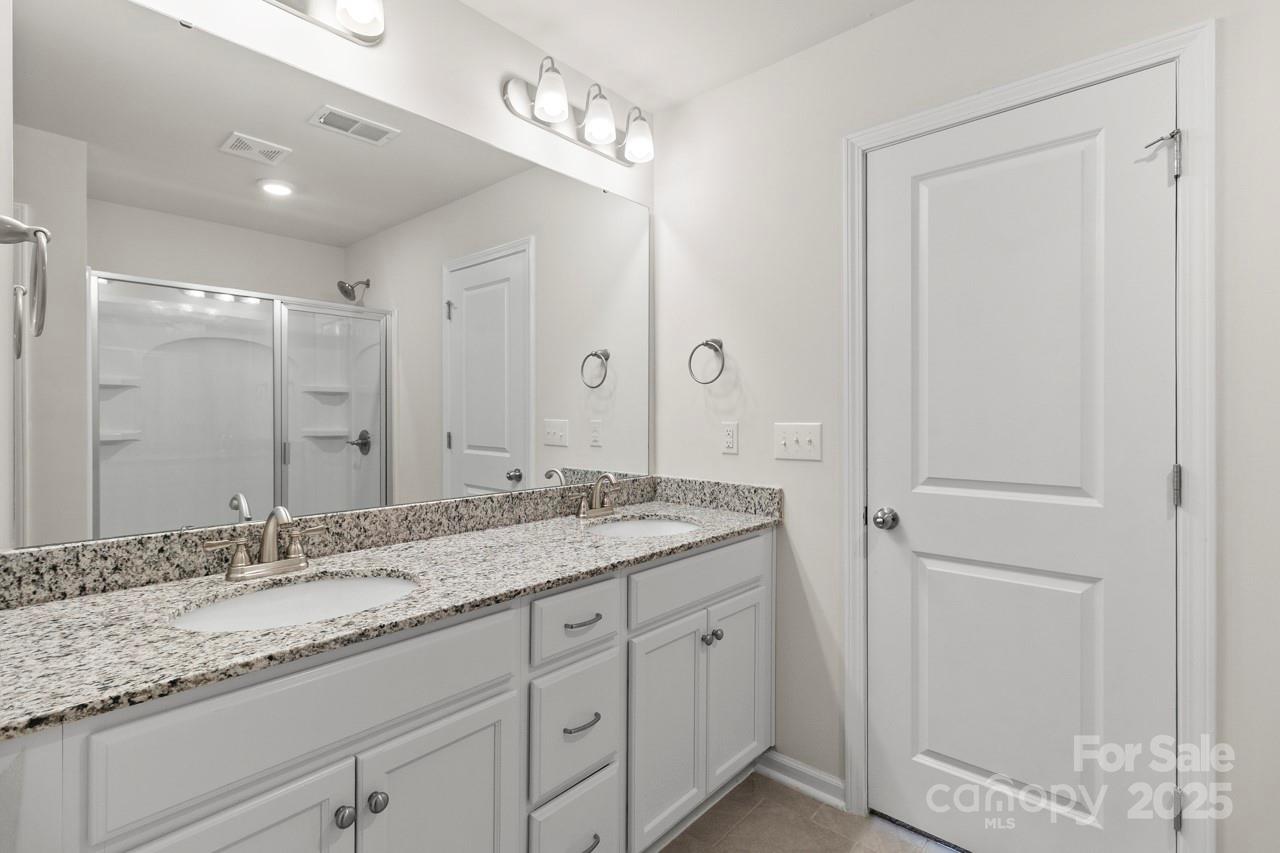 3776 Yorkshire Place Terrell, NC 28682 - Photo 27 of 47 a bathroom with a granite countertop sink and a mirror