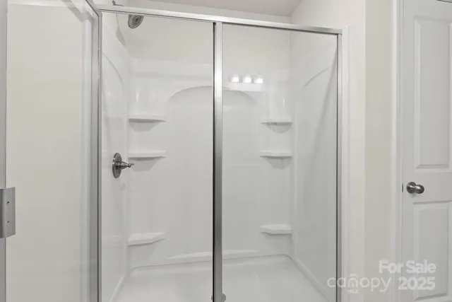 a white toilet sitting in a bathroom next to a sink