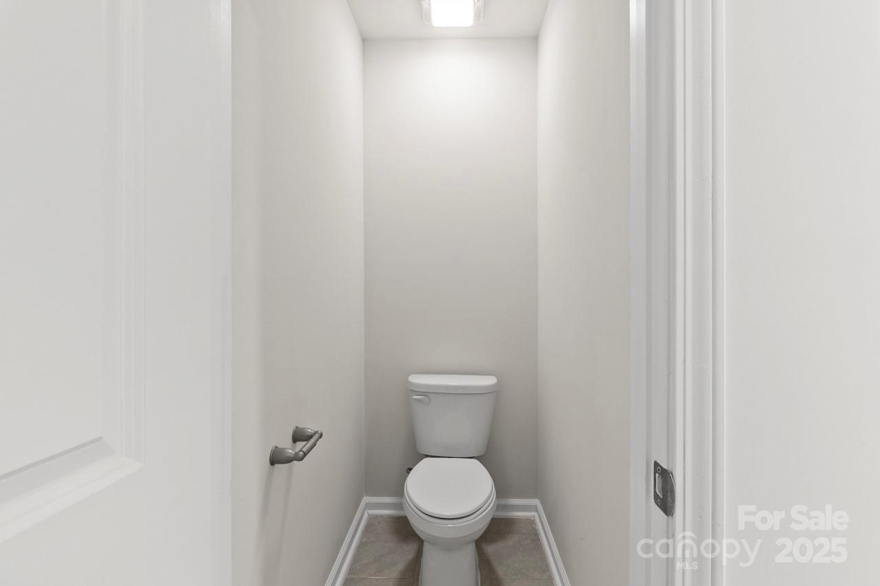 3776 Yorkshire Place Terrell, NC 28682 - Photo 29 of 47 a white toilet sitting in a bathroom next to a sink