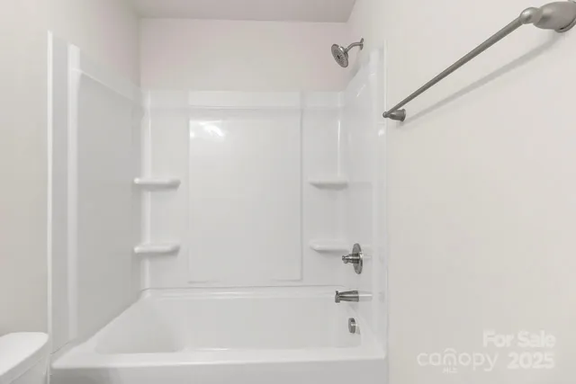 a picture of a bathroom with a shower and a mirror